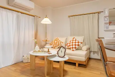 a living room with a couch and a table at Shinjuku 2 stops new mansion free WiFi nakano area in Tokyo