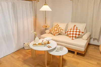 a living room with a couch and a table at Shinjuku 2 stops new mansion free WiFi nakano area in Tokyo