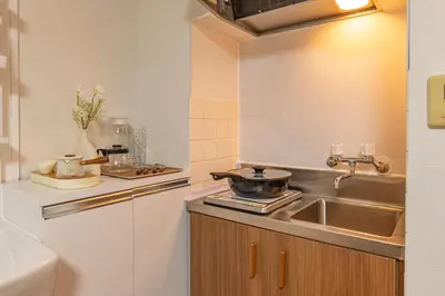 a kitchen with a sink and a pot on a stove at Shinjuku 2 stops new mansion free WiFi nakano area in Tokyo
