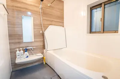 a bathroom with a white tub and a sink at Japanese style single-family house, three floors, 75 square meters, three bedrooms and one living room in Tokyo
