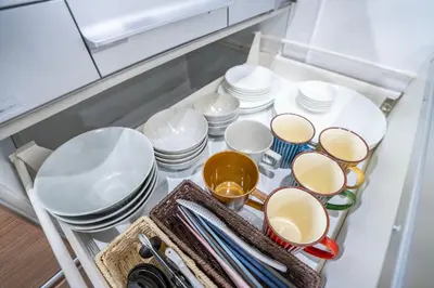 a drawer filled with plates and bowls and dishes at Japanese style single-family house, three floors, 75 square meters, three bedrooms and one living room in Tokyo