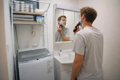 a man taking a picture of himself in a bathroom mirror at Japanese style single-family house, three floors, 75 square meters, three bedrooms and one living room in Tokyo
