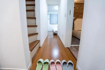 a hallway with stairs leading to a bedroom at Japanese style single-family house, three floors, 75 square meters, three bedrooms and one living room in Tokyo