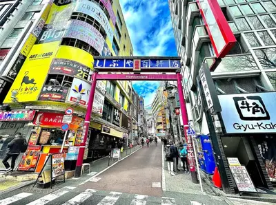 a city street with people walking through an archway between buildings at Sangenjaya 102 square meters 3 Bedroom 2 bathrooms in Tokyo
