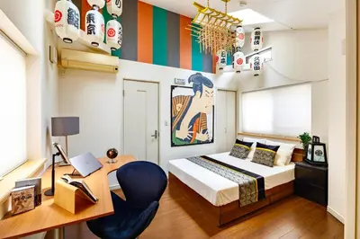 a bedroom with a bed and a desk with a laptop at Sangenjaya 102 square meters 3 Bedroom 2 bathrooms in Tokyo