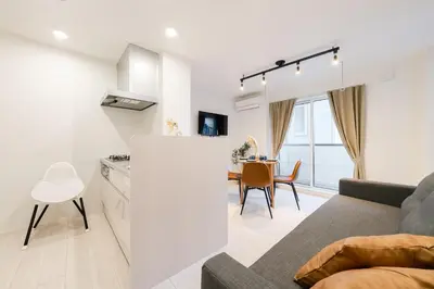 a kitchen and living room with a couch and a table at Househotel EKODA 201 HE21 in Tokyo