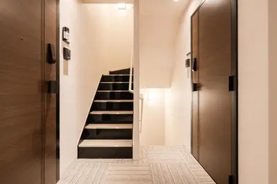 a staircase in a house with wooden doors at Househotel EKODA 201 HE21 in Tokyo