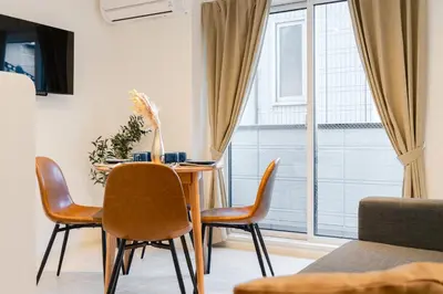 a dining room with a table and chairs and a window at Househotel EKODA 201 HE21 in Tokyo
