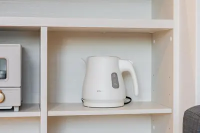 a white tea kettle sitting on a shelf at House hotel EKODA 202 HE22 in Tokyo