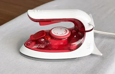 a red and white toaster sitting on a table at \u6c60\u888b\u672c\u753a3,4\u968e in Tokyo