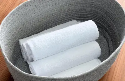 a basket filled with white paper towels on a table at \u6c60\u888b\u672c\u753a3,4\u968e in Tokyo
