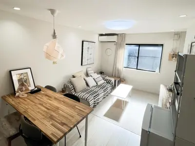 a living room with a table and a couch at \u65b0\u5bbf\u539f\u753a\u8cb8\u5207\u4e00\u8ed2\u5bb6 in Tokyo