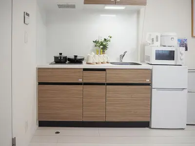 a kitchen with a white refrigerator and a microwave at \u685c\u306e\u5ddd50 \u6771\u4eac\u6674\u7a7a\u585410\u5206\u949f\u672c\u6240\u543e\u59bb\u6a4b\u99c55\u5206\u949f5\u4eba\u623f\u4e28 Tokyo skytree 10 mins Honjo Azumabashi 5 minutes5 people in Tokyo