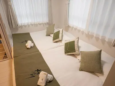 a large bed with pillows on it in a room at \u685c\u306e\u5ddd50 \u6771\u4eac\u6674\u7a7a\u585410\u5206\u949f\u672c\u6240\u543e\u59bb\u6a4b\u99c55\u5206\u949f5\u4eba\u623f\u4e28 Tokyo skytree 10 mins Honjo Azumabashi 5 minutes5 people in Tokyo