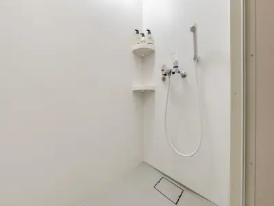 a shower in a white bathroom with a sink at Shinjuku 2min 140 Square meters VR Switch Photo Booth pc in Tokyo