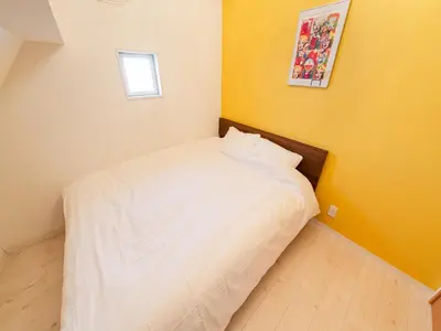 a small bedroom with a white bed and a window at Shinjuku 2min 140 Square meters VR Switch Photo Booth pc in Tokyo
