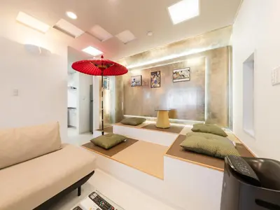 a living room with a couch and a red umbrella at Shinjuku 2min 140 Square meters VR Switch Photo Booth pc in Tokyo