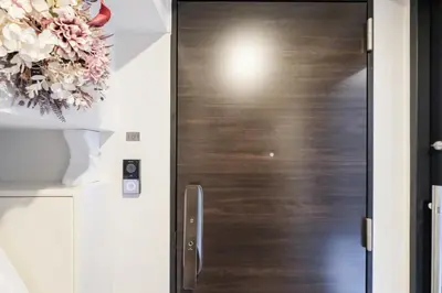 a door in a room with a flower wreath at Mi-HOTEL QUALIA SHINJUKU in Tokyo