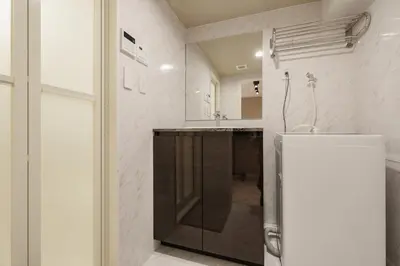 a kitchen with a sink and a refrigerator at Mi-HOTEL QUALIA SHINJUKU in Tokyo