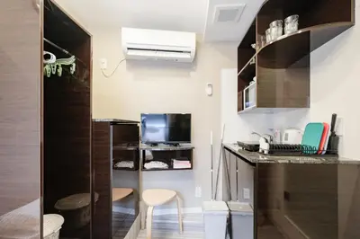 a small kitchen with a counter and a tv at Mi-HOTEL HEARTS SHINJUKU in Tokyo