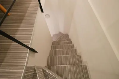 a spiral staircase in a building with a stair case at Mi-HOTEL HEARTS SHINJUKU in Tokyo