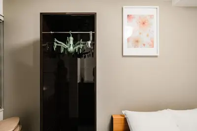 a bedroom with a chandelier hanging from a wall at Mi-HOTEL HEARTS SHINJUKU in Tokyo