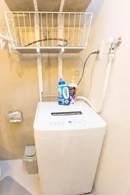 a washing machine with a basket on top of it at Fox & Fortune 4A -Nomad Stay- 3-min Walk, PS5, Apple Studio in Tokyo