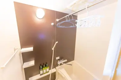 a bathroom with a shower and a toilet at Fox & Fortune 4A -Nomad Stay- 3-min Walk, PS5, Apple Studio in Tokyo