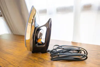 a iron sitting on top of a wooden table at Fox & Fortune 4A -Nomad Stay- 3-min Walk, PS5, Apple Studio in Tokyo