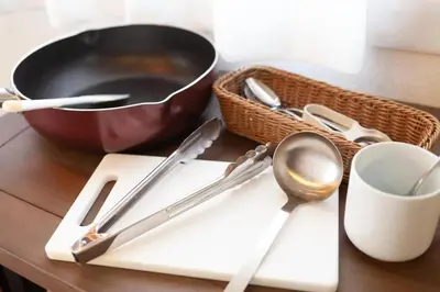 a table with utensils and a frying pan and a bowl at 25Yamanote JR line Takadanobaba sat 5mit Netflix watch!Up to 3 people! in Tokyo