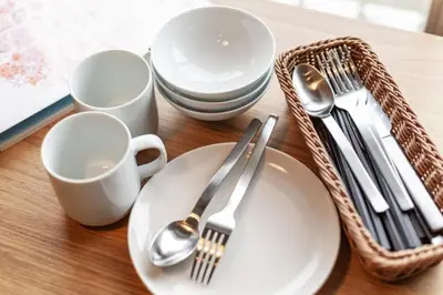 a table with plates and utensils and a basket at 25Yamanote JR line Takadanobaba sat 5mit Netflix watch!Up to 3 people! in Tokyo
