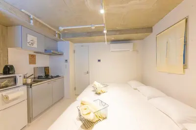 a small room with a bed and a kitchen at Fox & Fortune 4B -New Near station Luggage storage Netflix- in Tokyo