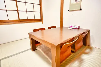 a wooden table with chairs and a box on it at Alice\u5c0f\u5c4b601 in Tokyo