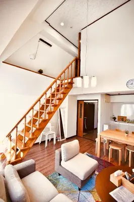 a living room with a staircase and a table at Alice\u5c0f\u5c4b601 in Tokyo