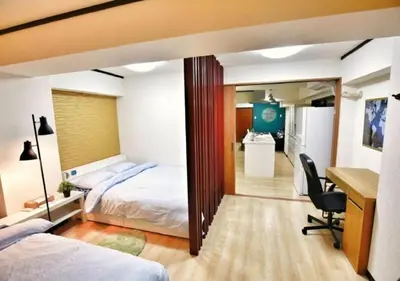 a hotel room with two beds and a desk and a desk at Alice 501 in Tokyo