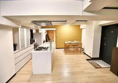 a kitchen and living room with a counter and a table at Alice 501 in Tokyo