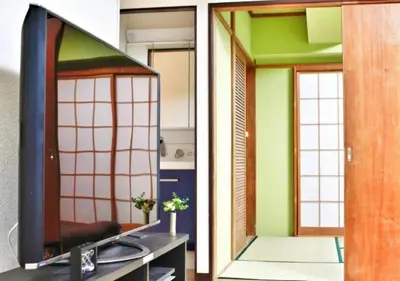a living room with a tv and a mirror at Alice 501 in Tokyo