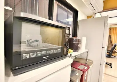 a microwave oven with a sink in a kitchen at Alice 501 in Tokyo