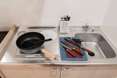 a frying pan sitting on top of a kitchen sink at saiei hotel 302 in Tokyo