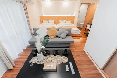 a small room with a bed and a couch at saiei hotel 302 in Tokyo