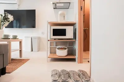 a living room with a tv and a pair of shoes at saiei hotel 401 in Tokyo