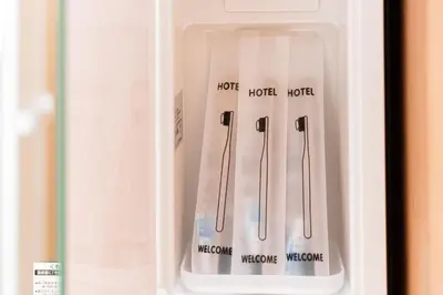a refrigerator door with two utensils in it at saiei hotel 401 in Tokyo