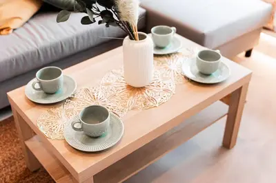 a coffee table with three cups and a vase on it at saiei hotel 401 in Tokyo