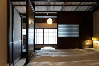 a bedroom with a large bed with a window at Hotel Suzumeya Tsukiji plus kitchen in Tokyo