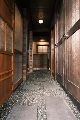 an empty hallway with wooden walls and a door at Hotel Suzumeya Tsukiji plus kitchen in Tokyo
