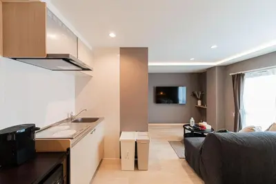a kitchen and living room with a couch and a sink at saiei hotel 402 in Tokyo