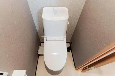 a white toilet in a bathroom next to a wall at saiei hotel 402 in Tokyo