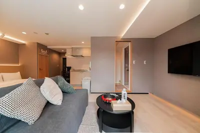 a living room with a couch and a television at saiei hotel 402 in Tokyo