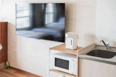 a kitchen with a sink and a microwave at saiei hotel 501 in Tokyo