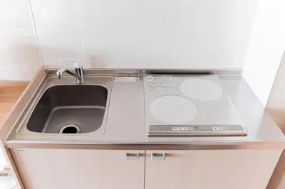a kitchen counter with a sink and a microwave at saiei hotel 501 in Tokyo
